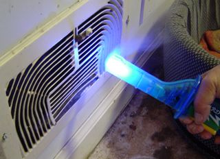 Wizard Stick being used to find air leakage during a Blower Door test