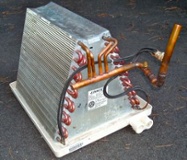 The evaporator coil absorbs heat from the house in the refrigeration cycle.