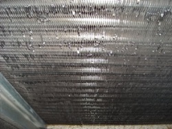 The latent cooling load is removed by water vapor condensing on the evaporator coil. 