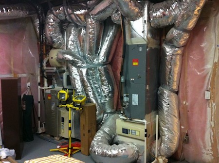 Vapor barrier on a basement wall in a 4 million dollar home (with a ductopus!)