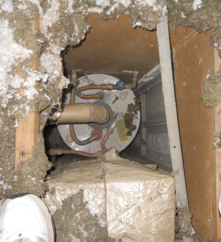 A furnace and water heater in a hall closet open to the attic