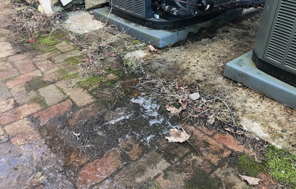 Ice on a sidewalk from melted heat pump frost
