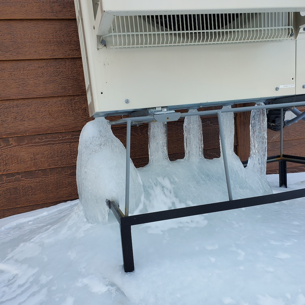 Stalagmites of refrozen melted frost beneath an outdoor unit in Minnesota [Courtesy of Randy Williams]