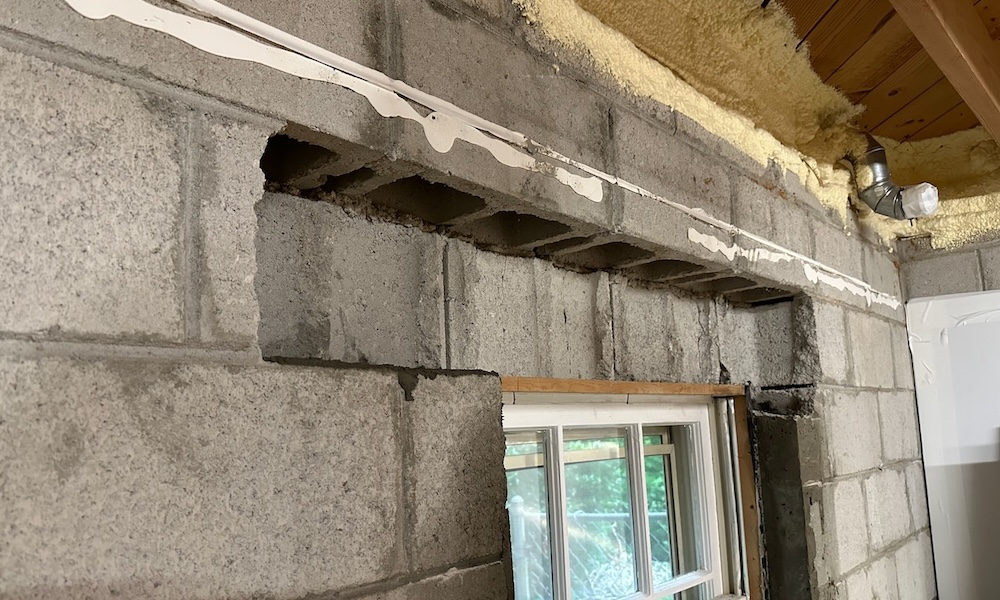 Broken concrete block above basement window