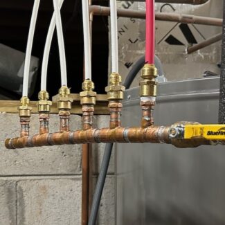 A Hot Water Manifold With 1/4 Inch And 3/8 Inch PEX Tubing